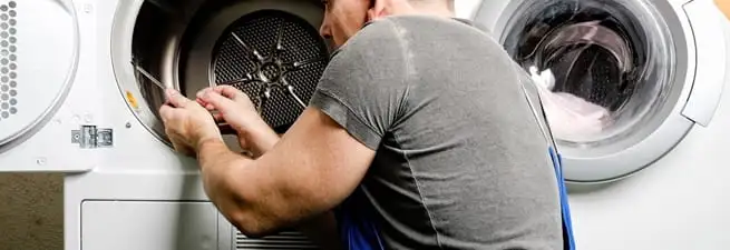 Dryer repair technician fixing a clothes dryer drum in Norfolk, VA