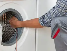 Dryer repair technician diagnosing and servicing a clothes dryer in Norfolk, VA