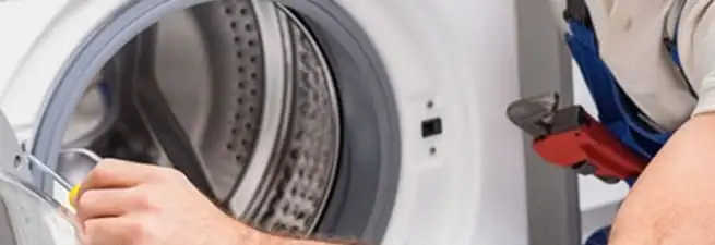 Appliance technician repairing a clothes dryer drum and internal parts in Norfolk, VA