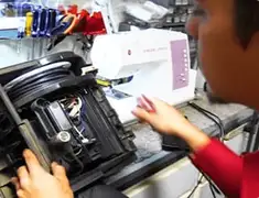 Vacuum repair technician servicing internal components on a workbench in Norfolk, VA