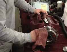 Vacuum repair technician cleaning and servicing a vacuum motor in Norfolk, VA