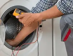 Washing machine repair technician testing a front-load washer with diagnostic tools in Norfolk, VA