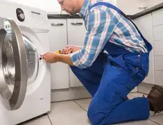 Washing machine repair technician servicing a front-load washer in Norfolk, VA